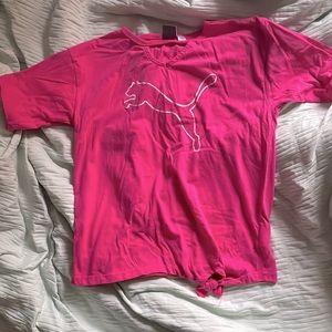 Pink puma shirt with glittery white puma, tie at the bottom.